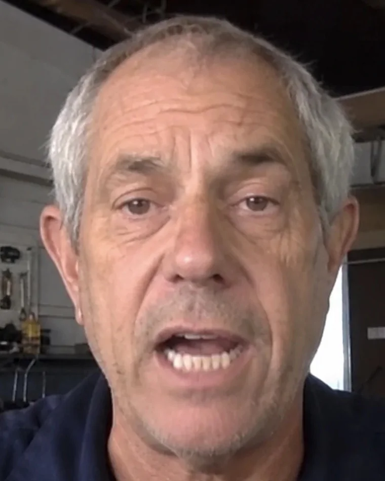 Mike, host of Fishing With Mike, talking to the camera in his workshop